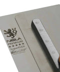 Close-up of NELA Premium Superflex Finishing Trowel 11 By 4.3 Inches With Cork Handle BiKo Grip, showcasing stainless blade.