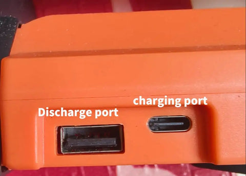Charging and discharge ports on Portable Camping Fan With Led Lights And 20000mAh Battery, orange casing