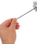 Hand holding an iron hook from the Beefy Slatwall Hooks Set 50 Pcs Heavy Duty Iron Utility Hooks For Phone Accessories Pegboard And Retail Shelf Organization Quick No Tool Setup Large Capacity Space Saving And Easy Install
