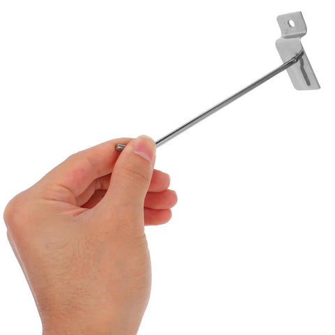 Hand holding Heavy Duty Iron Slatwall Hooks For Phone Accessories Set Of 50 Silver Slatwall Display Hangers For Pegboards And Retail Displays Easy Setup Space Saving Durable And Versatile