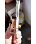 Close-up of the Ropematic Pro Manual Rope Puller for Fish Tape and Mule Tape Pulling, showing handle grip and metal frame