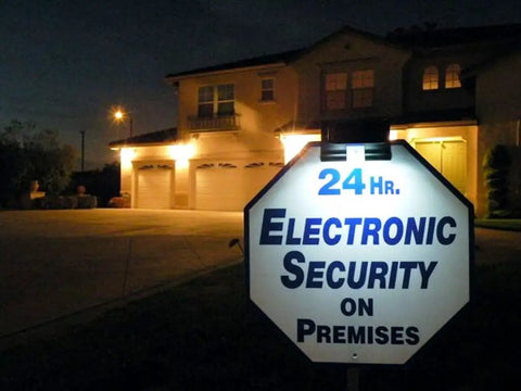 Wunder Solar Powered Spotlight Ultra Bright 3X LED Clip On Stick On Outdoor Light illuminating security sign at night