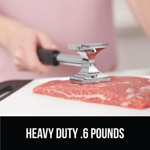 Dual Sided Meat Tenderizer Tool With Patented Design Beefy Heavy Duty Aluminum Mallet in use on beef steak