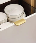 Edge Finger Pulls For Cabinets Invisible Concealed Aluminum Flat Hidden Drawer Pulls with Brushed Brass finish on a kitchen cabinet.