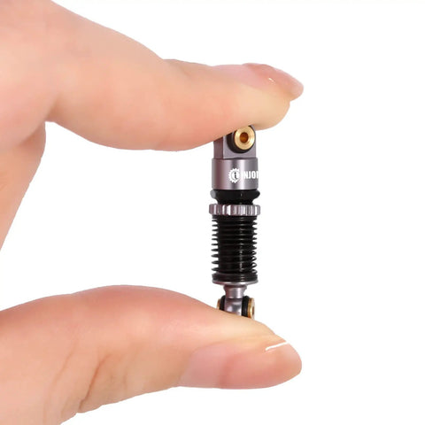 Person holding Beefy 43mm Aluminum Threaded Shocks Absorbers For 1/24 SCX24 RC Crawlers Grey, CNC Machined Shock Bodies