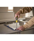 Person using 6 Way Screwdriver Set With Space Saving Design And Chrome Plated Bar For Corrosion Resistance Ergonomic Handle For Comfort