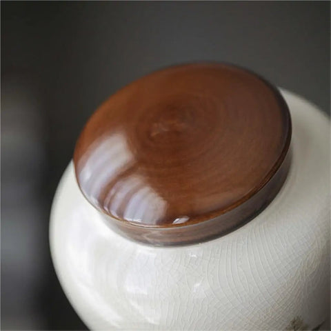Top Tier Ceramic Loose Tea Storage Jar With Secure Lid featuring a smooth brown wooden lid for kitchen organization.