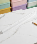 Top Shelf White Plastic Cabinet Drawer Slides Six Pack Side Mount Runners on marble surface with a pencil.
