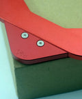 Pro Grade Aluminum Router Table Round Corner Template With Hella Sharp Radius Gauges close-up on red aluminum material with screws.