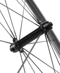 Close-up of 700C Carbon Wheelset with 45mm Deep Rim, showing rim brake and quick release QR 9X100 front hub detail for road bikes.