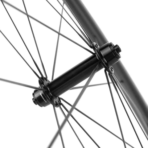 Close-up of 700C Carbon Wheelset with 45mm Deep Rim, showing rim brake and quick release QR 9X100 front hub detail for road bikes.