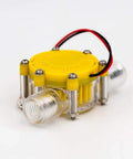 Front view of a Water Turbine Micro Hydroelectric Power Generator For DIY Off Grid Charging LED Lighting And Devices DC Up To Eighty Volts Ten Watt Output No Internal Regulator Great For Charging Small Batteries And Phones, with a yellow cap and two clear connectors.