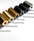 Various metal finishes including polished chrome, antique black, and brushed brass samples for wall sconce fittings.