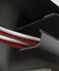 Close-up of 46-inch black J Channel Cable Raceway With Self Adhesive Backing organizing wires under a desk