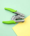 Crop-A-Dile Power Punch For One Quarter Inch Holes Scrapbooking Tool on paper, showing green handles and metal punch.