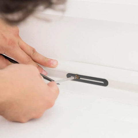 Person installing adjustable stainless steel flat joining plates with slot holes for wood furniture repair