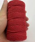 Red roll of Macrame Cord 1.5mm Cotton String Rope For DIY Crafts 109 Yards With 35 Color Options held in a hand