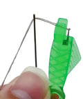 Close-up of Five Piece Fish Type Needle Threaders for Sewing Machines and Hand Sewing, demonstrating threading a small eye needle.