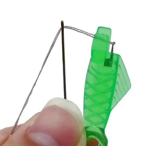 Close-up of Five Piece Fish Type Needle Threaders for Sewing Machines and Hand Sewing, demonstrating threading a small eye needle.