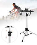 Rock Solid Three Point Bike Repair Stand And Display Rack with adjustable height shown beside cyclist, aluminum frame, three leg base.