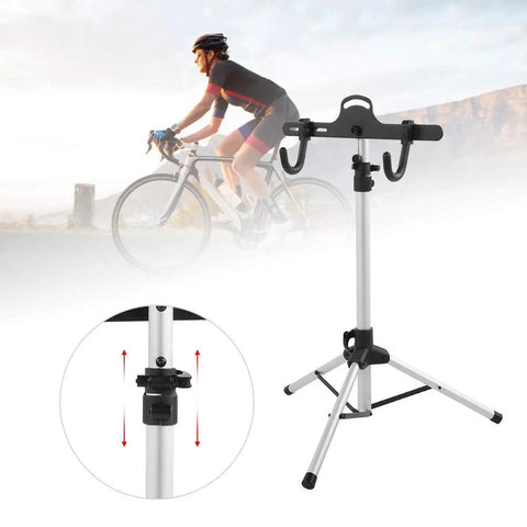 Rock Solid Three Point Bike Repair Stand And Display Rack with adjustable height shown beside cyclist, aluminum frame, three leg base.