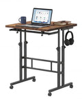 Mobile Split-Top Sit Stand Desk With Nifty Cup Holder, Smooth-As-Butter Manual Height Adjustment Knobs, Ergonomic Workstation For Killer Posture, Easy Transition Between Sitting And Standing Zero Hassle Setup For Home Office with laptop, cup, and books.