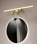 Brass Vanity Light With Adjustable LED Spotlights for Makeup Mirror, 56cm, mounted above circular mirror in bathroom setting