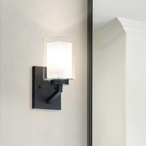 Four Light Vanity Light Fixtures Over Mirror Black Metal Finish With Dual Glass Shades mounted on a wall beside a mirror