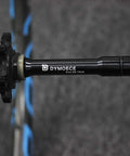 Close-up of aluminum alloy Front 15mm Thru Axle to 9mm Quick Release Skewer Adapter for 100mm Forks mounted on a bike wheel hub.