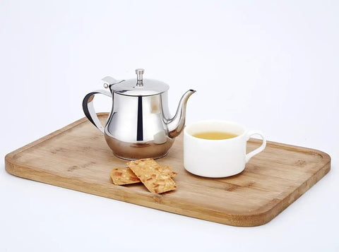 Mini 360Ml Stainless Steel Teapot For Tea And More on wooden tray, with cup of tea and crackers