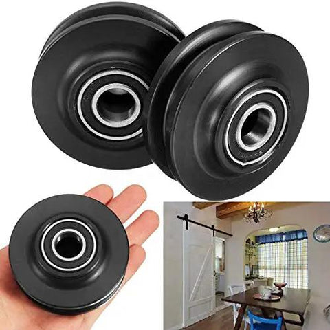 Built Tough Double Bearing Barn Door Pulley Wheel With Super Slick Gliding Ball Bearings For Sliding Cabinet And Window Track Hardware Zero Fuss Installation 15 mm Outer Diameter Plastic And Metal Build displayed in hand and on table.