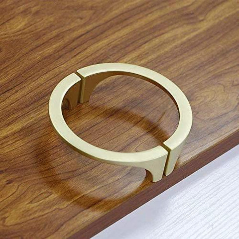 Two Pair Cabinet Hardware Handles In Golden Copper Brushed Gold Finish On Wooden Surface