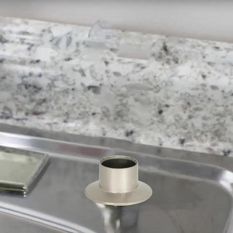 Close-up view of Heavy Duty Universal Faucet Hose Guide In Brushed Nickel mounted on a kitchen sink deck.