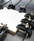 Six Pack CNC Arcuate Press Plate Clamps T Slot Hold Down Fixture securing material on a milling machine table.