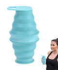 Foldable Silicone Water Bottle For Travel And Gym, ultra lightweight leak proof hydration flask in turquoise, in use by woman.