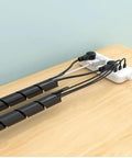 Spiral Cable Wrap 1/2 Inch Black, 23 Ft Long Wire Organizer on wooden table for cable management, protecting wires from wear