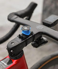 Bike Handlebar And Stem Phone Mount Kit With MAG Universal Adapter And Dual Lock on black handlebar of red bike.