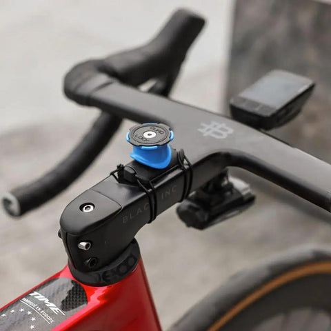 Bike Handlebar And Stem Phone Mount Kit With MAG Universal Adapter And Dual Lock on black handlebar of red bike.