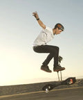 Person performing trick on RipStik Caster Board Classic Collection Two Wheel Skateboard With 360 Degree Casters For Kids Teens And Adults