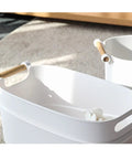 Top Shelf White Plastic Storage Basket With Lidless Opening For Zero Fuss Organization And Straight Up Space Saving Efficiency Ideal For Cozy Living Room Or Bedroom Vibes with wooden handles in soft natural light.