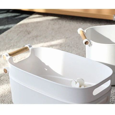 Top Shelf White Plastic Storage Basket With Lidless Opening For Zero Fuss Organization And Straight Up Space Saving Efficiency Ideal For Cozy Living Room Or Bedroom Vibes with wooden handles in soft natural light.