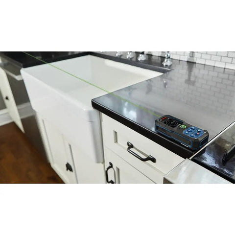 Blaze Green Beam Laser Measure on sleek countertop showing precise 165 ft real-time readings, for pros and DIYers.
