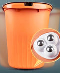 Four Pack Matte Black Swivel Caster Wheels Featuring Silent Stainless Steel Bearings And Buttery Smooth 360 Spin Performance Hassle Free Adhesive Mount For Effortless No Drill Furniture Cabinet Glide And Heavy Duty Household Moves, shown on an orange trash bin.