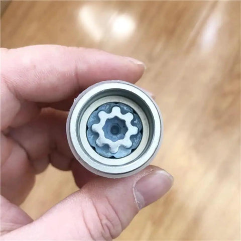 Ride Safe With This Lug Nut Removal Tool Perfect For Audi A3 A4 A6 Q5 And Q7 Models, Featuring Heavy Duty Cold-Forged Steel That Keeps Your Wheels Tight And Stable On Any Rough Road Trip. close-up steel wheel lock socket tool in hand