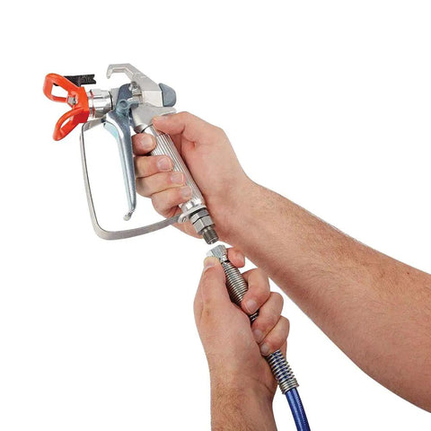 Hands holding a spray gun connected to a 50 Foot Upgraded Airless Paint Hose For Graco Sprayers With Reinforced Brass Wire Braid