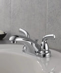 Foundations Centerset Chrome Bathroom Faucet with 2-Handle and Metal Pop-Up Drain, shown on a white sink.