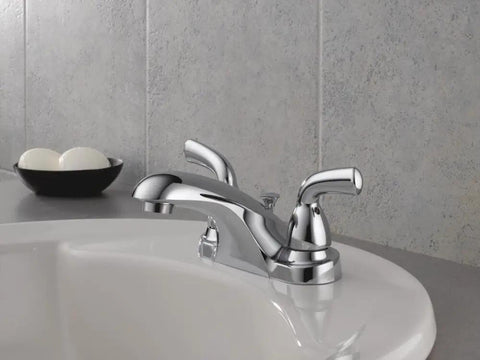 Foundations Centerset Chrome Bathroom Faucet with 2-Handle and Metal Pop-Up Drain, shown on a white sink.