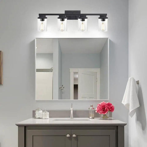 Four Light Vanity Light Fixture In Matte Black With Clear Glass Shades above bathroom mirror