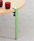Adjustable Metal Table Legs With Signature F Shape Profile And Self Leveling Base Heavy Duty Powder Coated Steel Construction No Drill Assembly green leg supporting a round table with red cups.