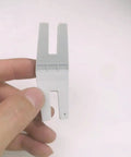 Close-up of gray tool from Two Piece Hump Jumper Sewing Tools Set For Quilting And Hemming in hand for precise edges.
